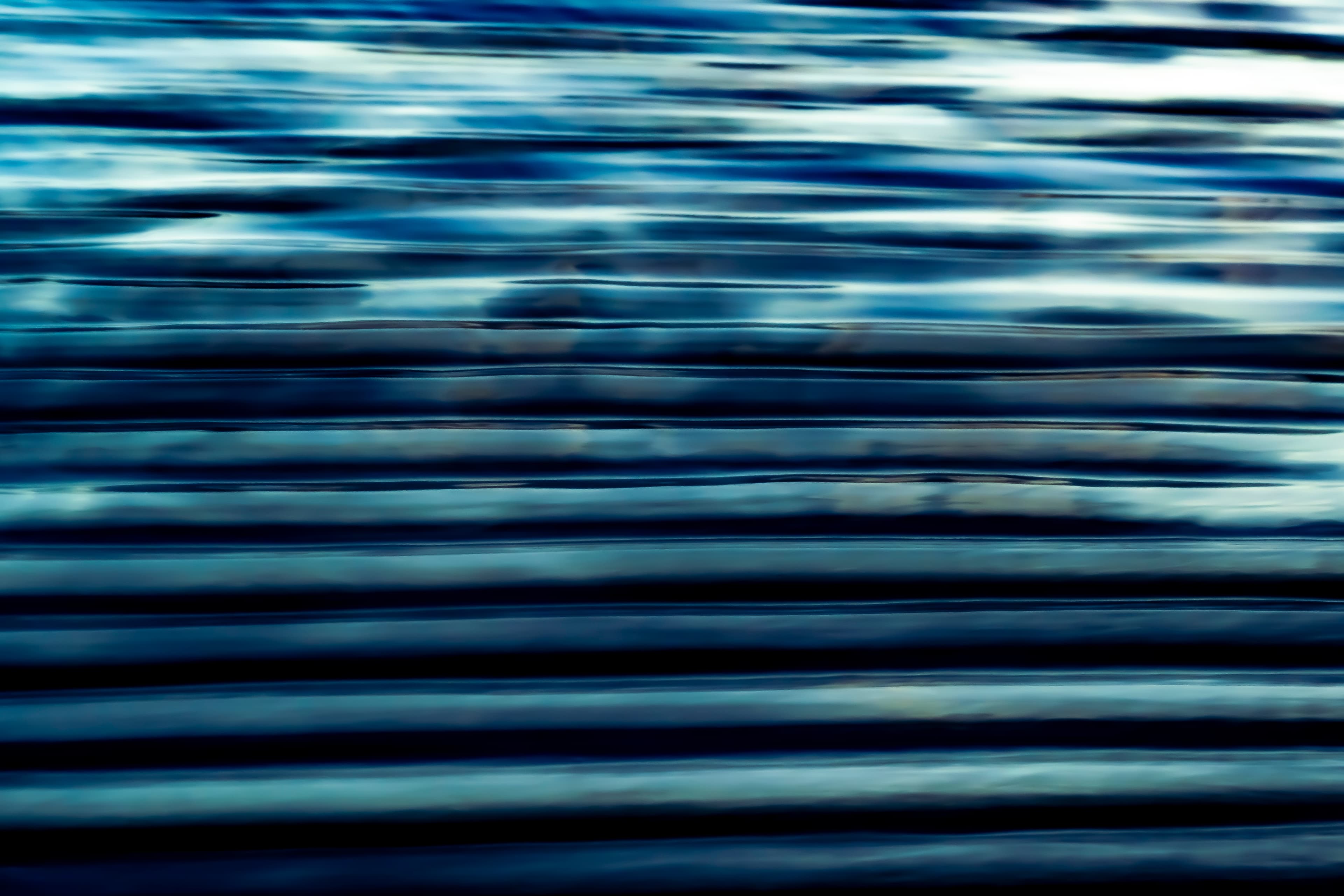 Slate blue horizontal lines of moving water — fine art ocean photography print, Whangamata NZ.