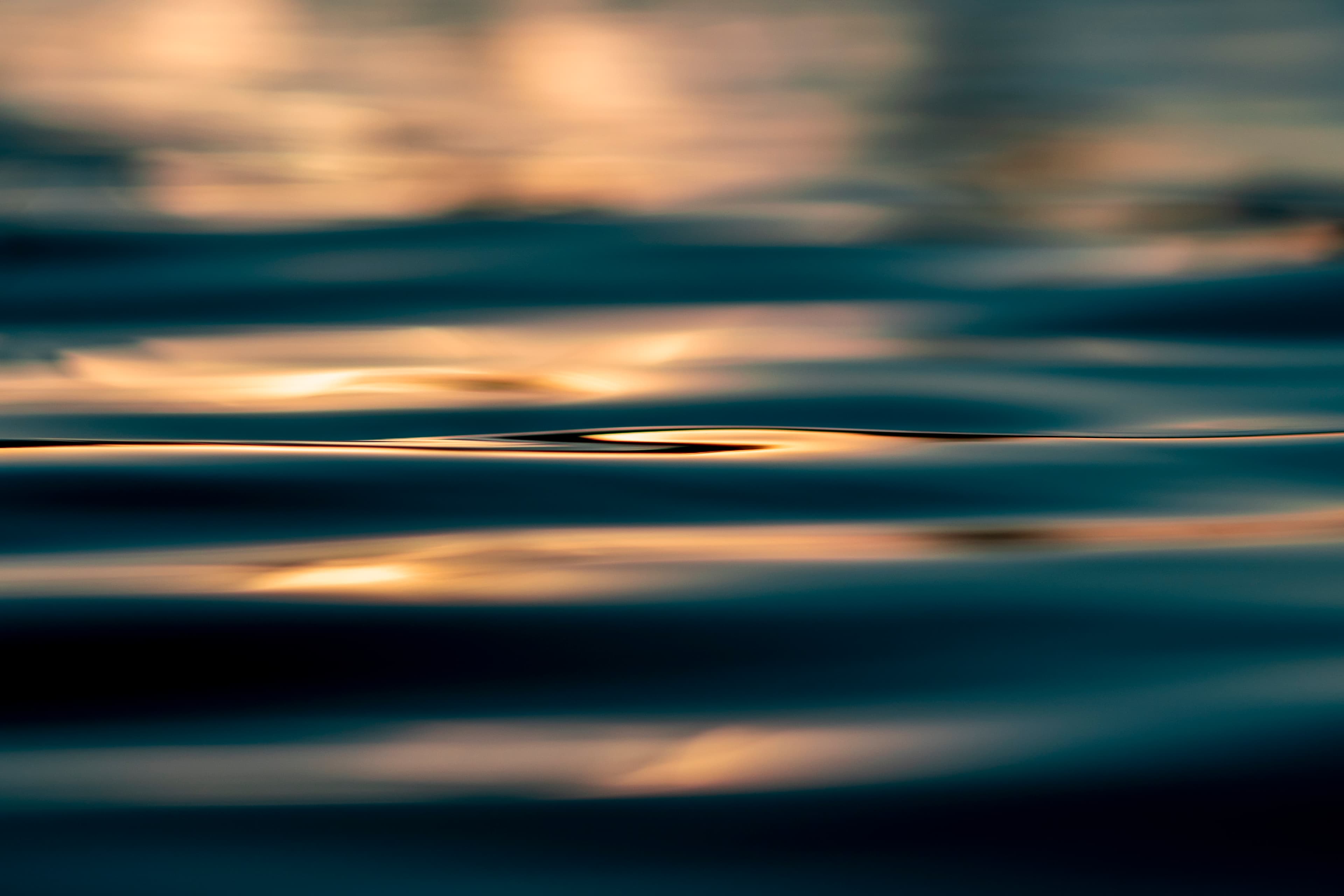 Hazy gold horizon reflected on calm water — fine art ocean photography print, Whangamata NZ.