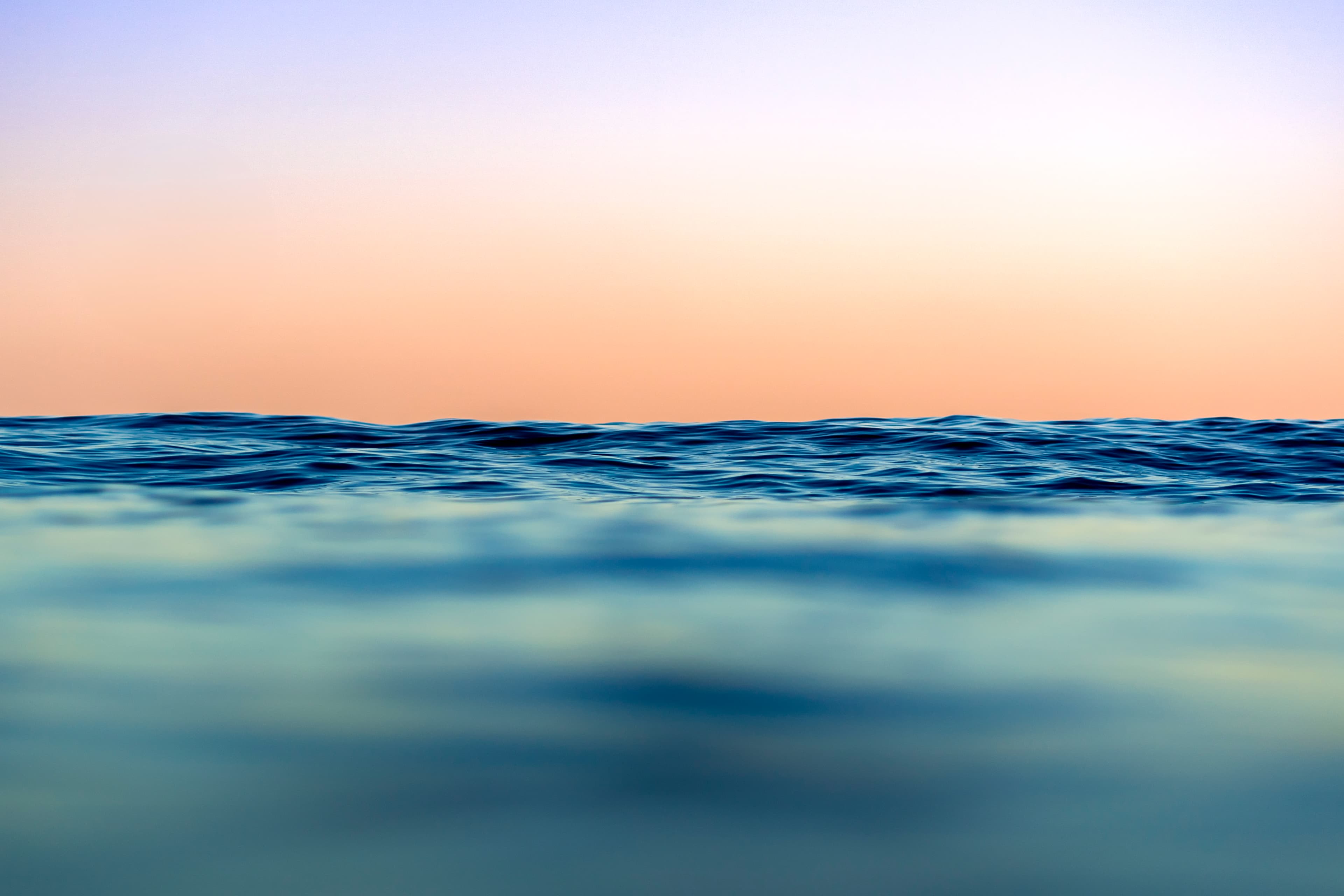 Dreamy pastel sunset horizon over gentle waves — fine art ocean photography print, Whangamata NZ.