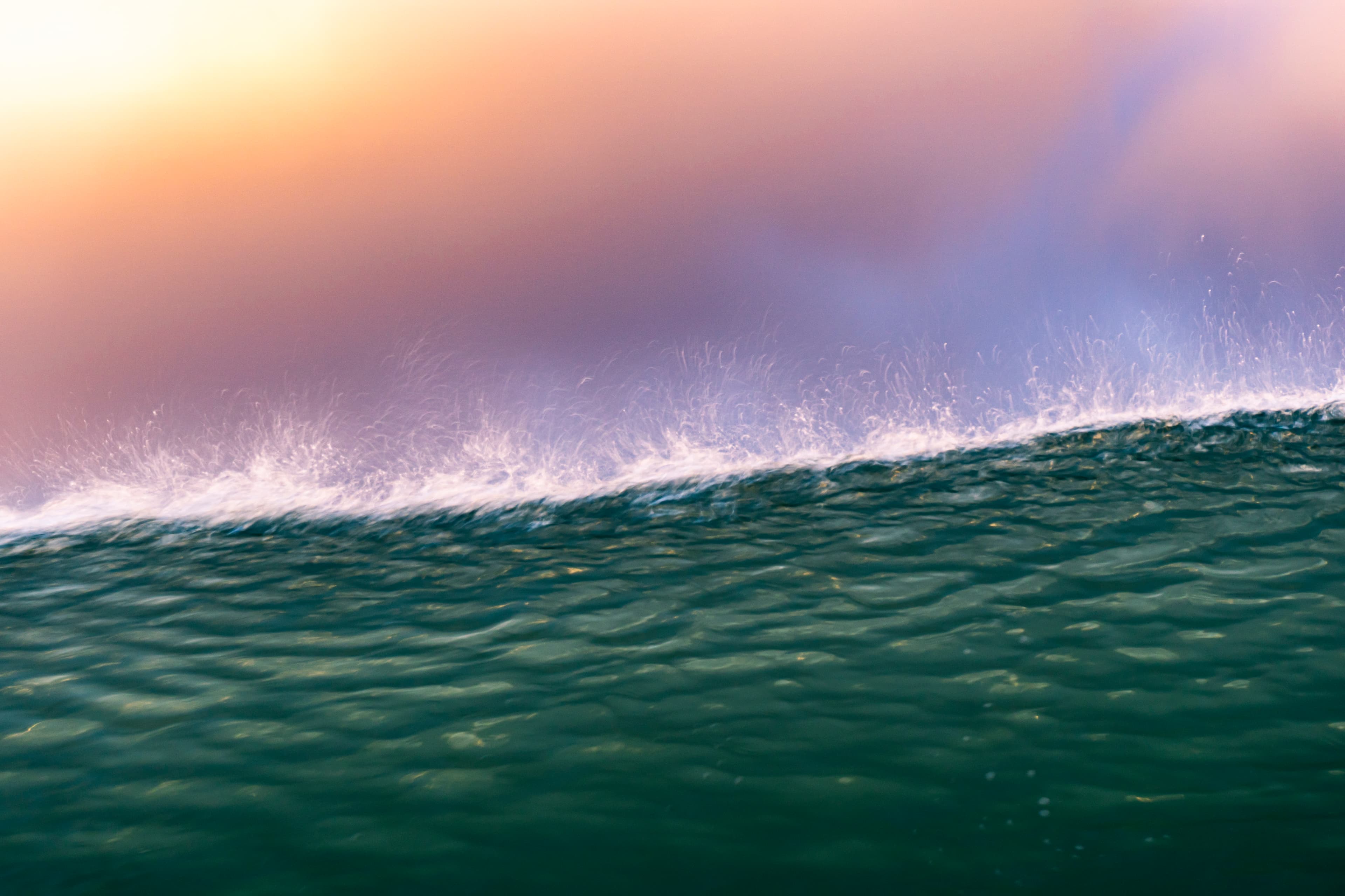 A breaking wave under a soft pastel dawn sky — fine art ocean photography print, Whangamata NZ.