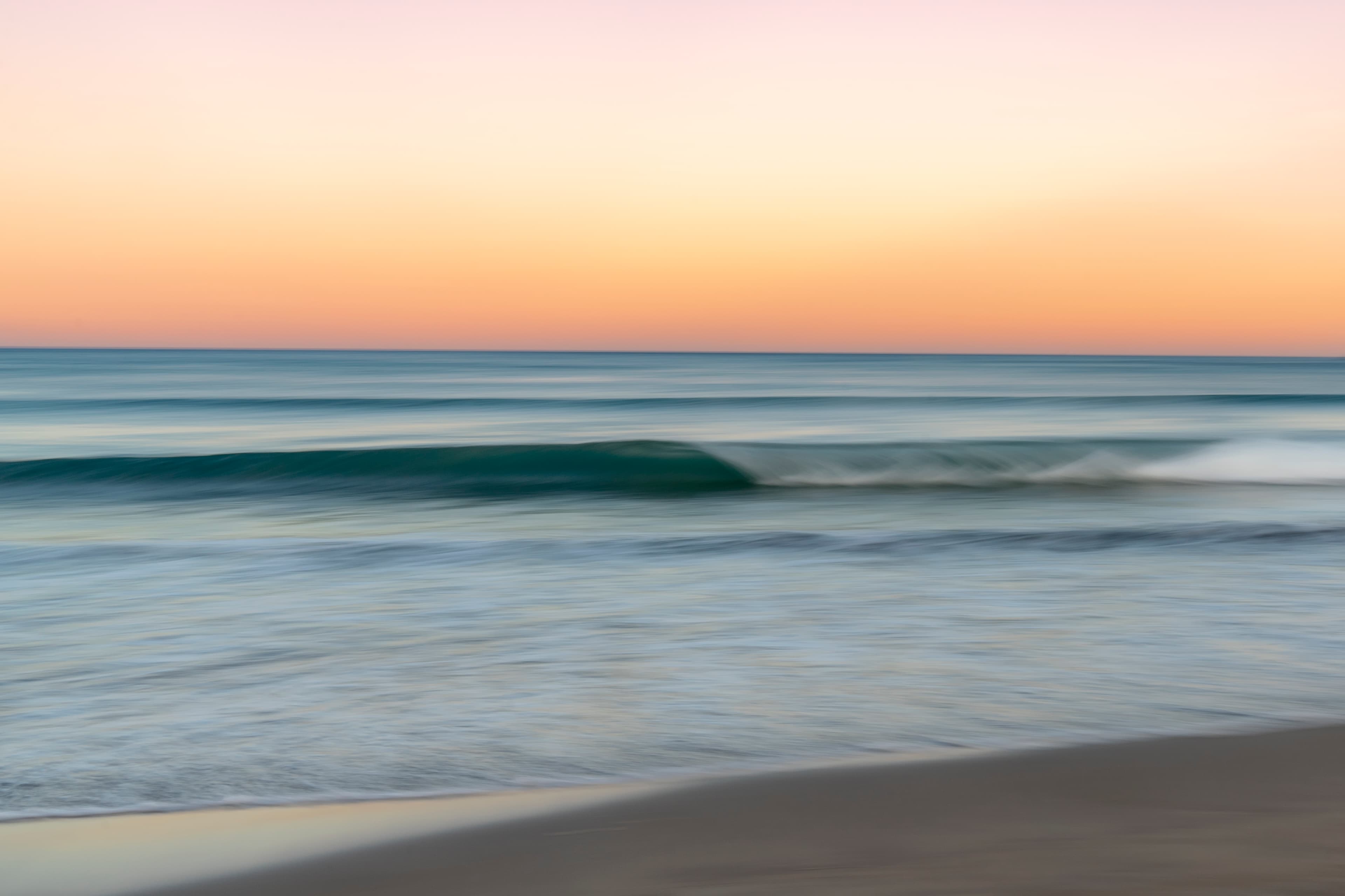 Soft swell rolling onto the shore at sunset — fine art ocean photography print, Whangamata NZ.